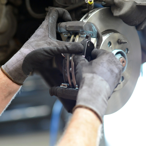 Mechanic working on automotive disc brake pad