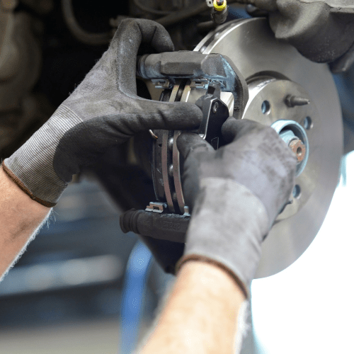 Mechanic working on automotive disc brake pad