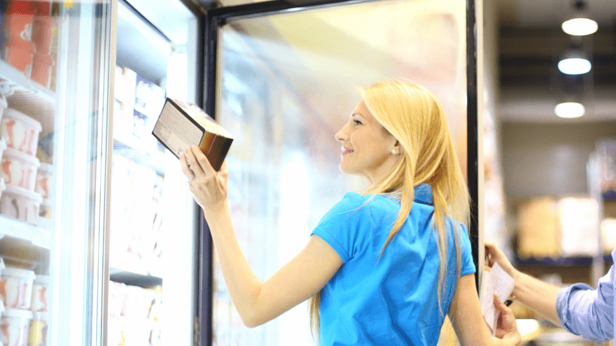 Woman using the display freezer