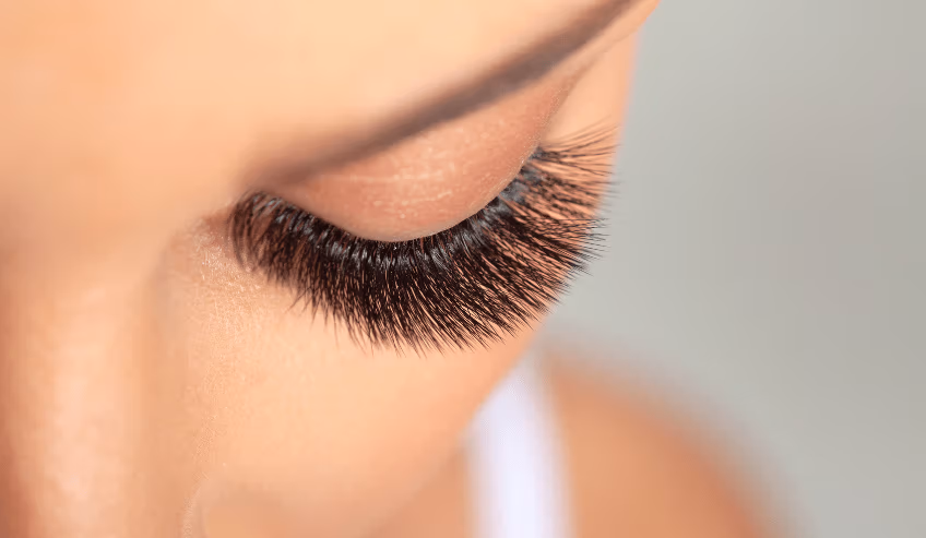 Professional volume eyelash extensions featuring a dense, feathery appearance