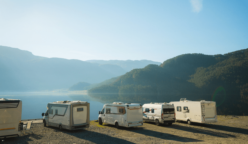 RV trailers parked beside a scenic mountain lake