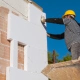 Man working on exterior wall finishing