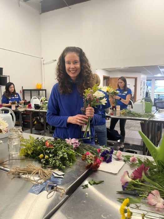 H.B. Fuller employees assembling flower arrangements for Bluebirds and Blooms